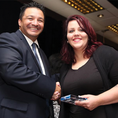A man shaking the hands of a woman